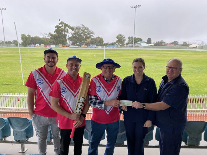 North Broken Hill Cricket Club team members Jordan Vella, Ethan Thomas and Dennis Watts present the $1500 to Oncology nurses Victoria Crook and Ben Stellini.