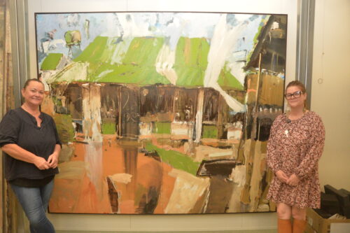 Kathy Graham and Cindi Gillmore with Luke Sciberras's 'Manager's Quarters Wilcannia' at the Broken Hill City Art Gallery