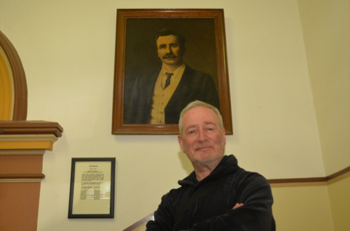 Phil Katz in front of Tom Mann's portrait at the Broken Hill Trades Hall